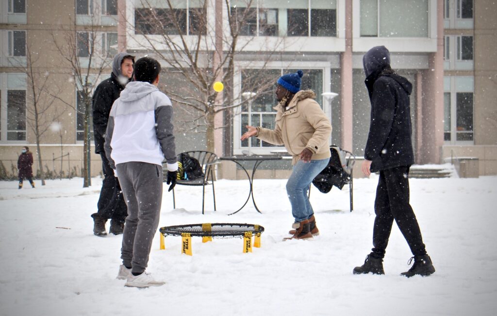 2021 02 19-e lee-philadelphia upenn-students and covid precautions game University of Pennsylvania students play a game on a snowy quad. (Emma Lee/WHYY)