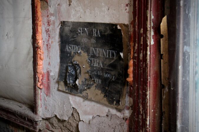 A Sun Ra poster remains affixed to the wall above the space where the floor collapsed into the sub-basement at the Sun Ra House