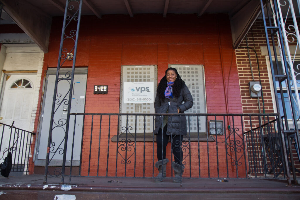 2021 03 02 k paynter PHA lottery-3 Racqueal Howard on the porch of the property she won in the Philadelphia Housing Authority-Jumpstart lottery in the Mantua section of West Philadelphia. She plans to renovate the home and sell it to a family. (Kimberly Paynter/WHYY)