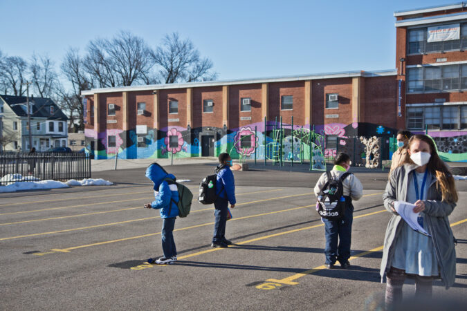 Students wait outside Wister Elementary School