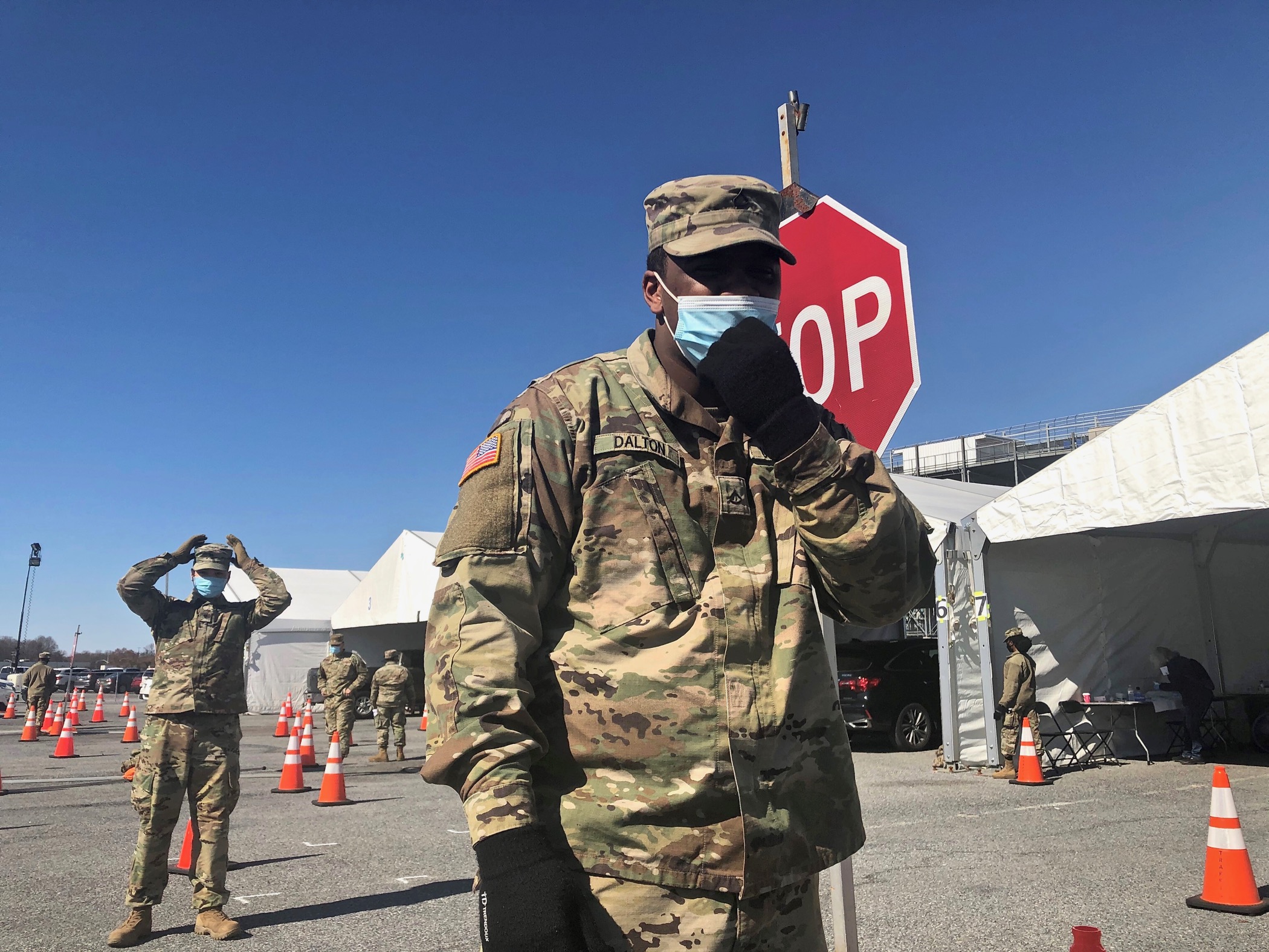 Pfc. Denzel Dalton wears a face mask and a National Guard uniform