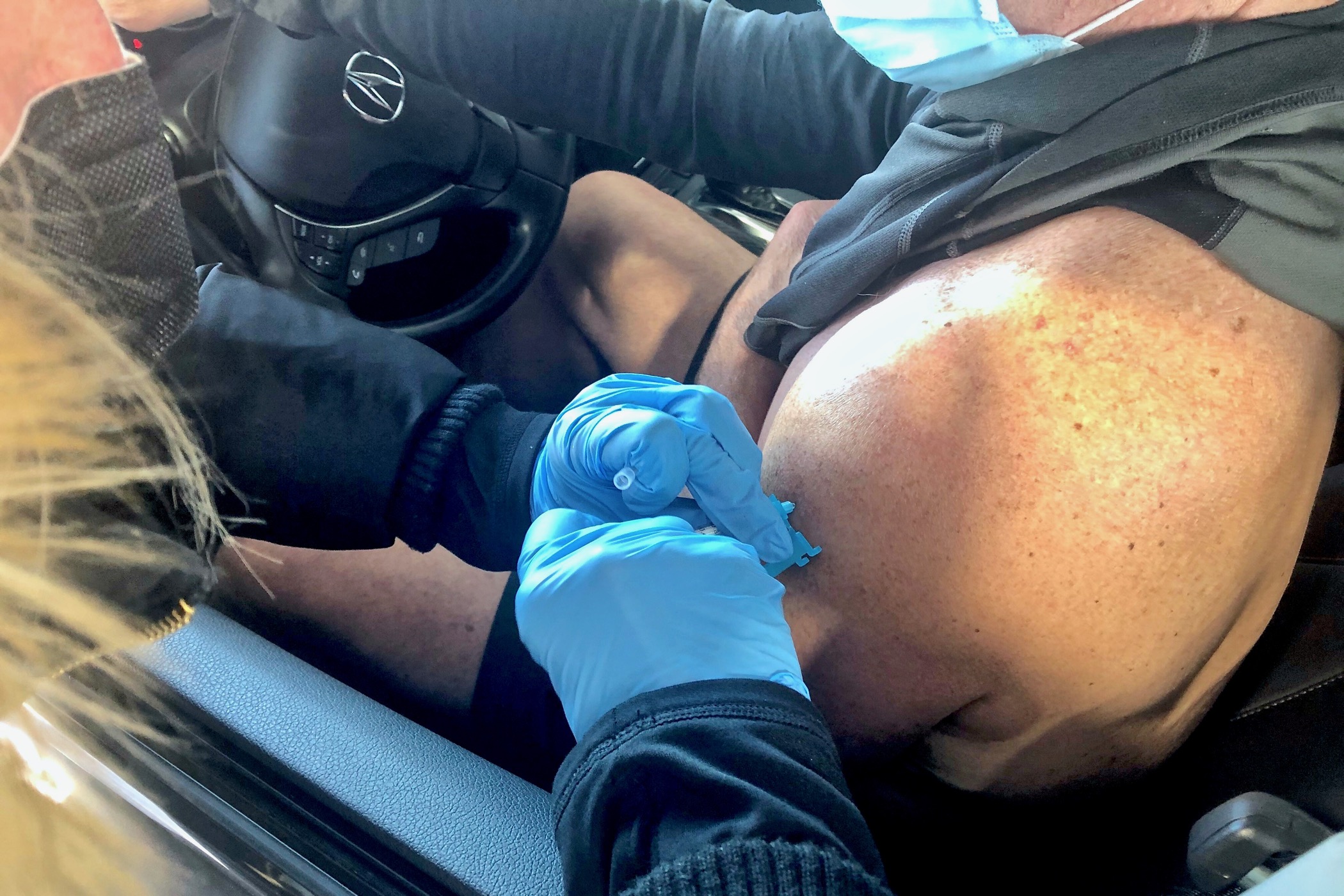 Cris Barrish gets his first injection of the Pfizer vaccine at Dover International Speedway