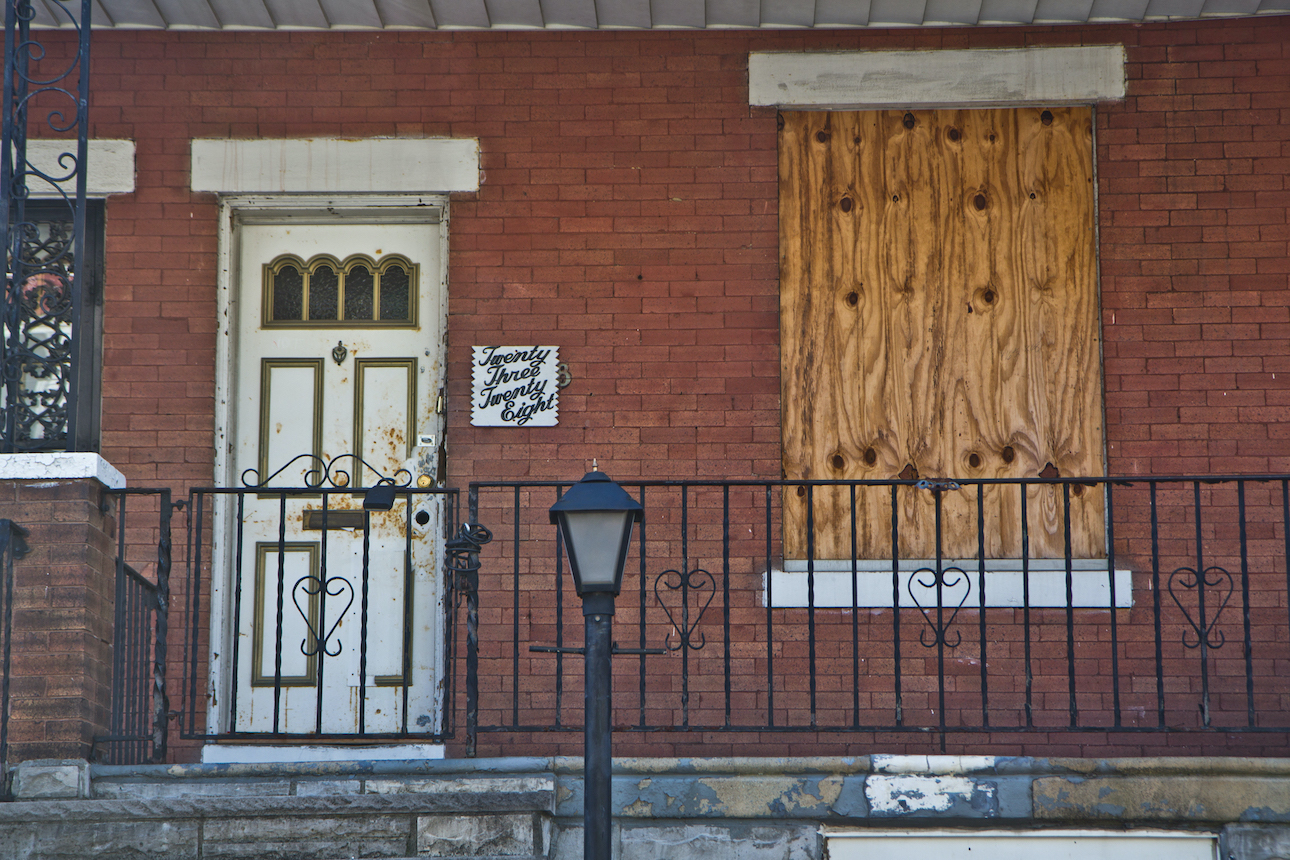A closeup of a boarded up house on Harold Street