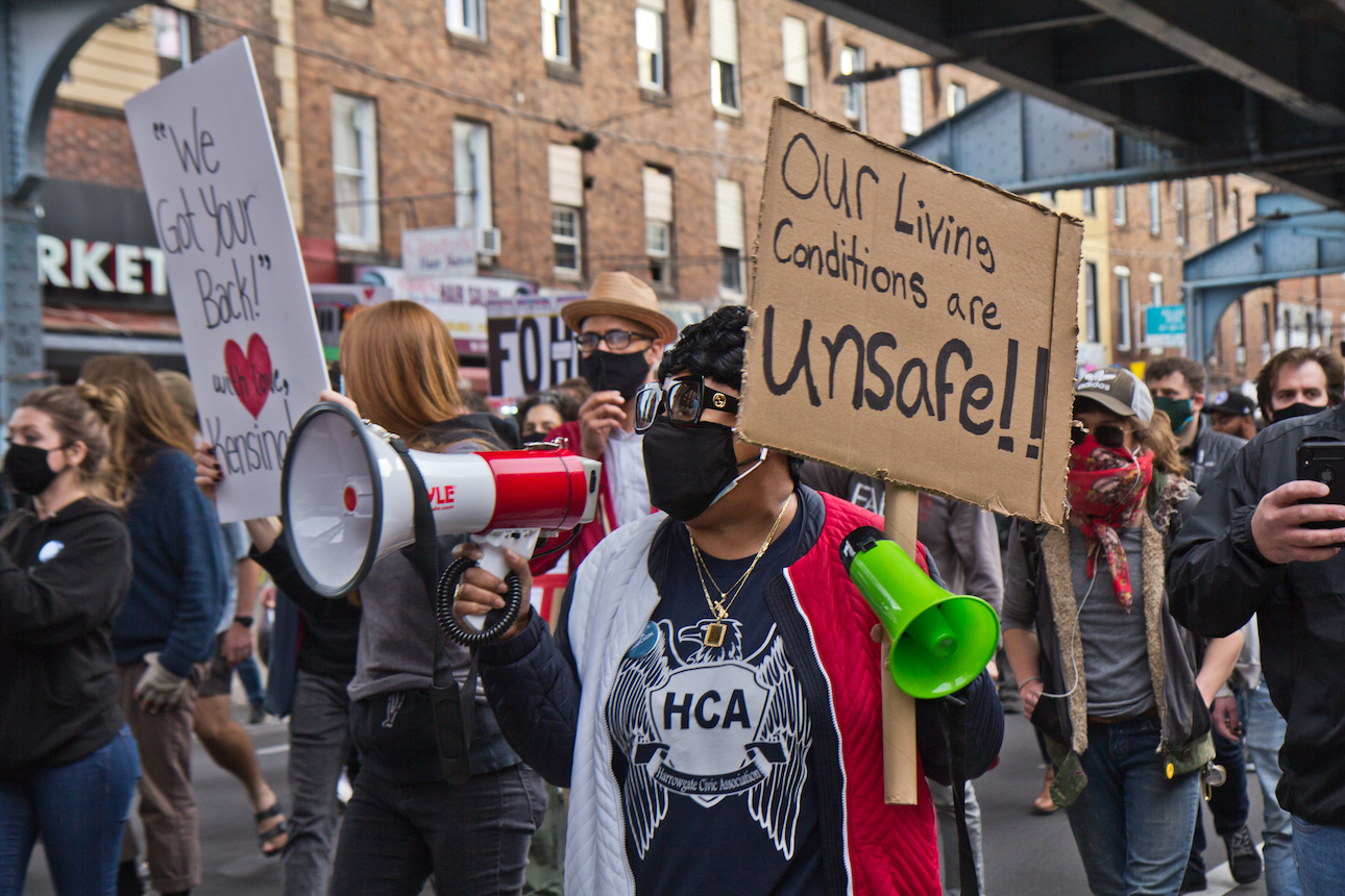 Darlene Burton speaks from a megaphone at a protest over Somerset Station's closure