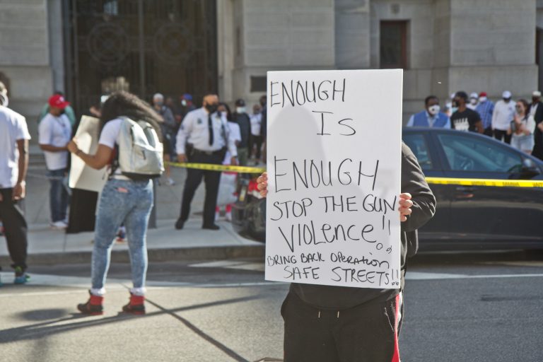 Activists hung caution tape around City Hall in Philadelphia on March 26, 2021, to bring the crime scenes they witness in their neighborhoods to city officials’ work place. (Kimberly Paynter/WHYY)