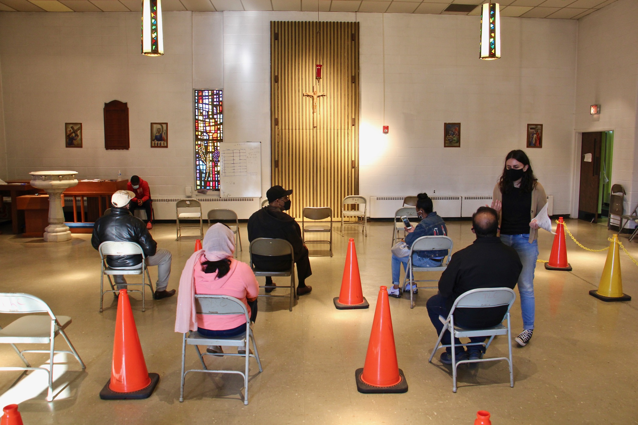 Patients wait to be vaccinated against COVID-19 at the Sayre Health clinic