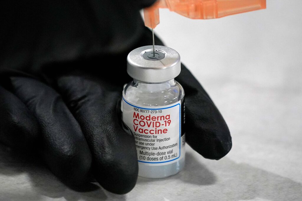 AP21028834865252 University of Pittsburgh Pharmacy student Edith Wang loads a syringe with a dose of the Moderna Covid-19 Vaccine, during a vaccination clinic hosted by the University of Pittsburgh and the Allegheny County Health Department at the Petersen Events Center, in Pittsburgh, Thursday, Jan. 28, 2021. (AP Photo/Gene J. Puskar)
