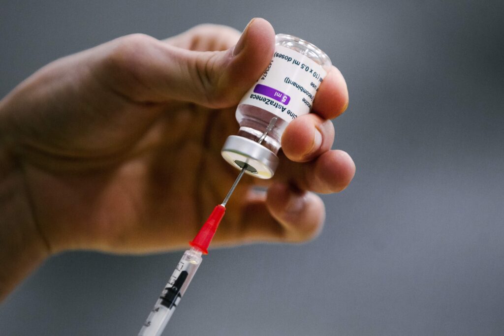 Virus Outbreak Belgium Vaccine A pharmacist prepares a syringe from a vial of the AstraZeneca coronavirus vaccine during