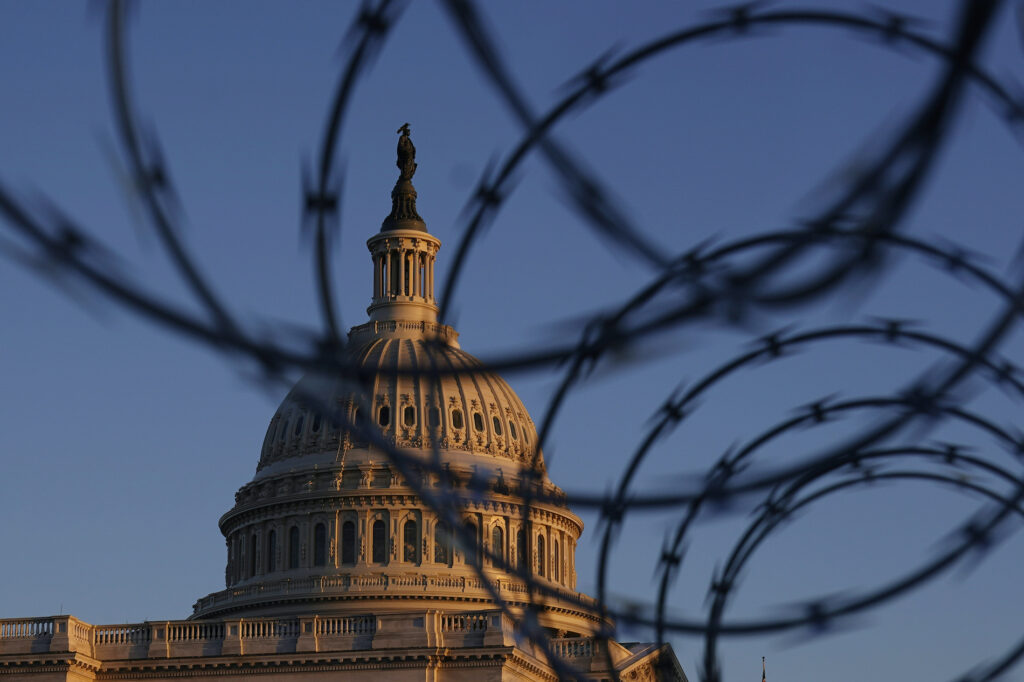 APTOPIX Capitol Breach Threat The Capitol is seen through razor wire at sunrise in Washington