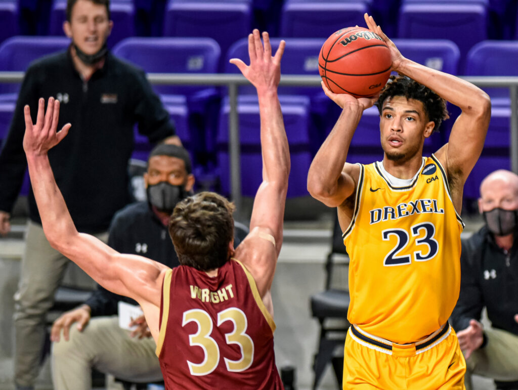 CAA Championship Basketball Drexel forward T.J. Bickerstaff (23) shoots over Elon forward Simon Wright (33) during the first half of an NCAA college basketball game for the Colonial Athletic Association men's tournament championship in Harrisonburg, Va., Tuesday, March 9, 2021. (AP Photo/Daniel Lin)