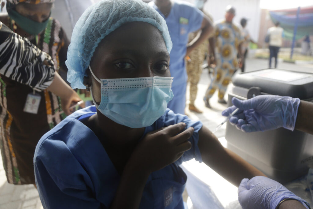 APTOPIX Virus Outbreak Nigeria Africa Vaccines Hospital worker receives one of the country's first coronavirus vaccinations, using the AstraZeneca vaccine manufactured by the Serum Institute of India and provided through the global COVAX initiative, at Yaba Mainland hospital in Lagos, Nigeria Friday, March 12, 2021. Urgent calls for COVID-19 vaccine fairness rang through African countries on Friday as more welcomed or rolled out doses from the global COVAX initiative, with officials acutely aware their continent needs much more. (AP Photo/Sunday Alamba)