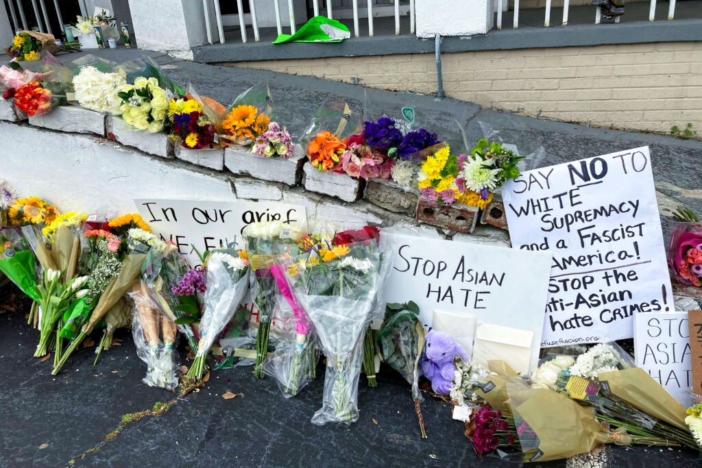 Racial Injustice Georgia Shootings Asian Women In this March 19, 2021, file photo, flowers, candles and signs are displayed at a makeshift memorial in Atlanta. (AP Photo/Candice Choi)