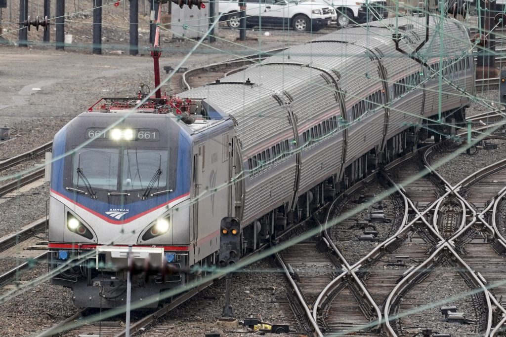 Biden Infrastructure An Amtrak train departs 30th Street Station in Philadelphia, Wednesday, March 31, 2021.