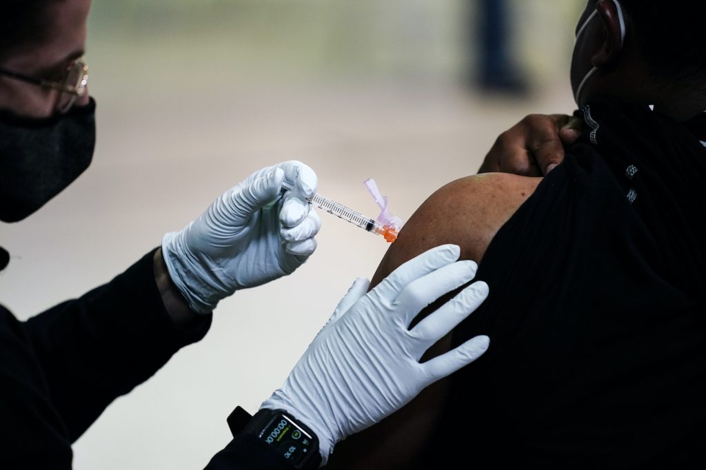 AP_coronavirus_vaccine_site_philly_032921_03.jpg A member of the Philadelphia Fire Department administers the Johnson & Johnson COVID-19 vaccine to a person at a vaccination site setup