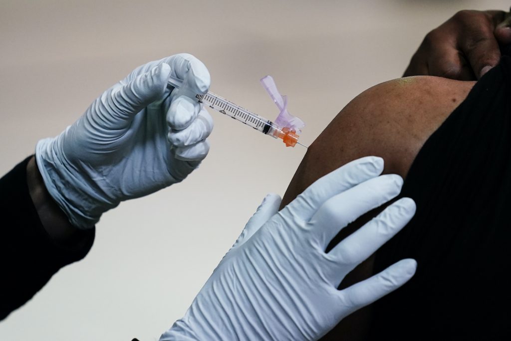 AP_coronavirus_vaccine_site_philly_032921_06.jpg A member of the Philadelphia Fire Department administers the Johnson & Johnson COVID-19 vaccine to a person at a vaccination site setup