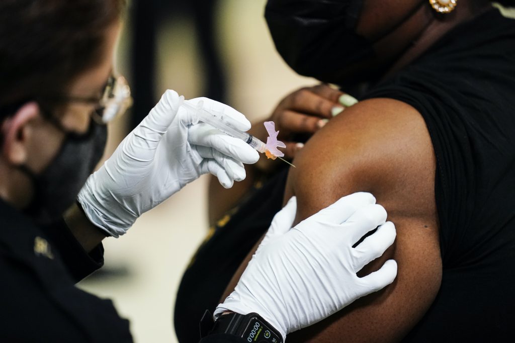 AP_coronavirus_vaccine_site_philly_032921_07.jpg A member of the Philadelphia Fire Department administers the Johnson & Johnson COVID-19 vaccine to a person at a vaccination site setup