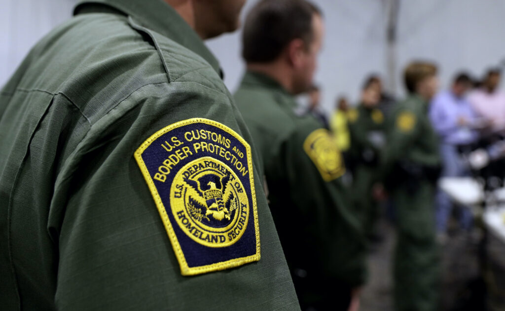 Immigration-Detained Children A close-up of a Border Patrol agent's uniform