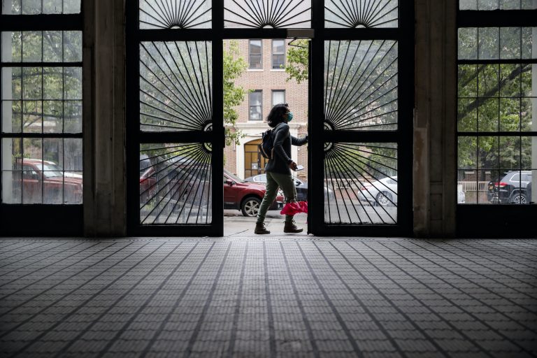 Dr. Jeanie Tse opens a door to leave a residence