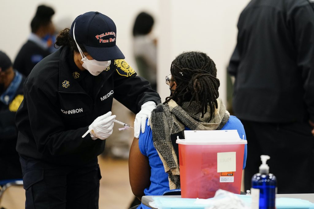 Virus Outbreak Pennsylvania A member of the Philadelphia Fire Department administers a COVID-19 vaccine at a vaccination site
