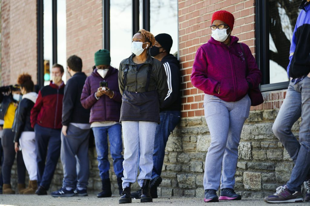 Virus Outbreak Pennsylvania People wearing face masks wait in line to receive COVID-19 vaccines