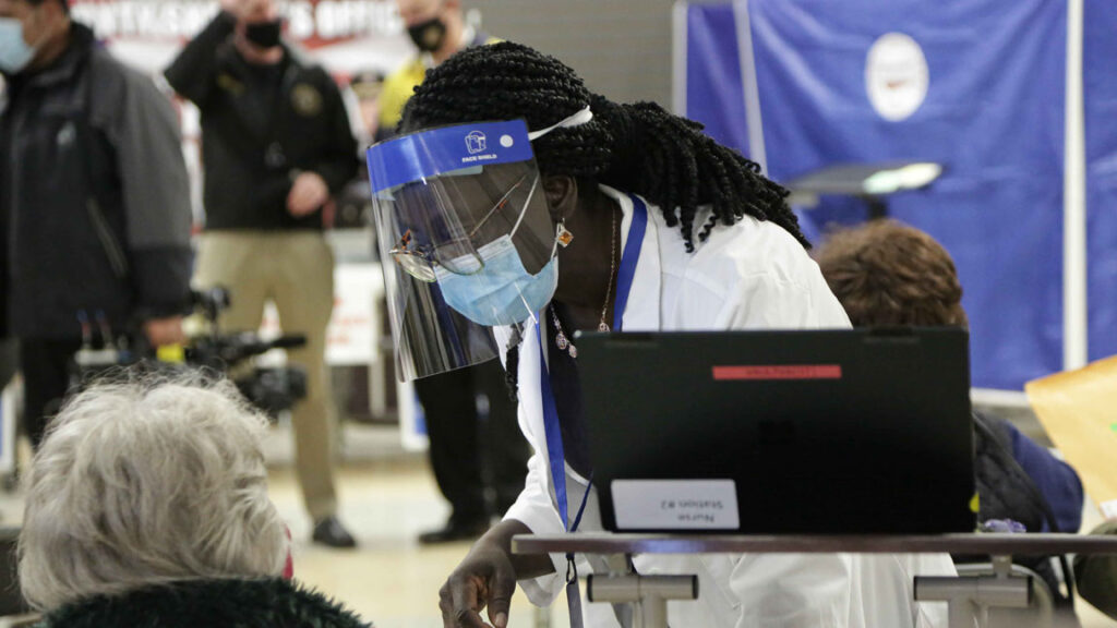 COVID-19-coronavirus-vaccine-vaccination-senior A health worker assists a resident at Passaic County’s vaccination site