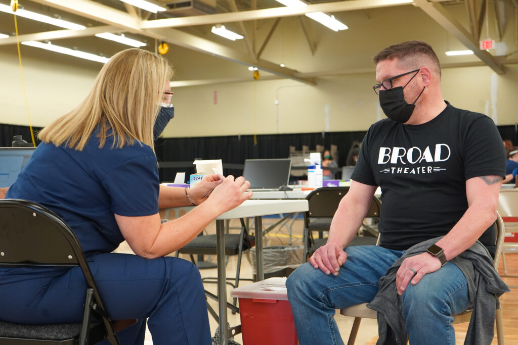DSC06185 Randy Loux, 48, is getting prepped for his COVID vaccine at the new Willow Grove site. (Kenny Cooper/WHYY)