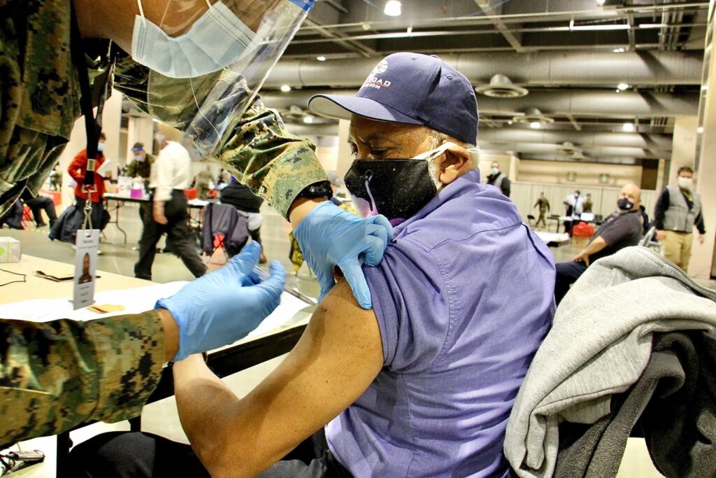 FEMA_coronavirus_vaccine_site_EL_030221_01 Garry Deans is vaccinated at FEMA's coronavirus vaccination center
