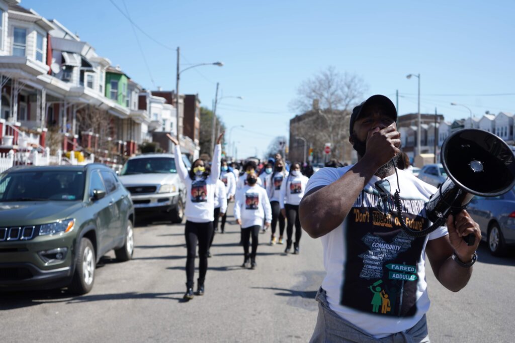 Fareed-Abdullah-with-crowd Fareed Abdullah leads a peace march against gun violence in Southwest Philadelphia on March 20, 2021. (Kenny Cooper/WHYY)