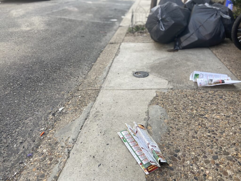 Pizza menus litter a South Philadelphia block. (WHYY)