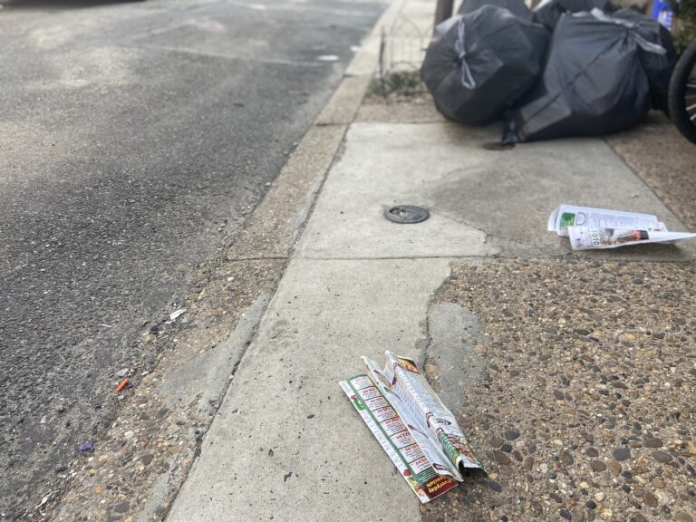Pizza menus litter a South Philadelphia block. (WHYY)
