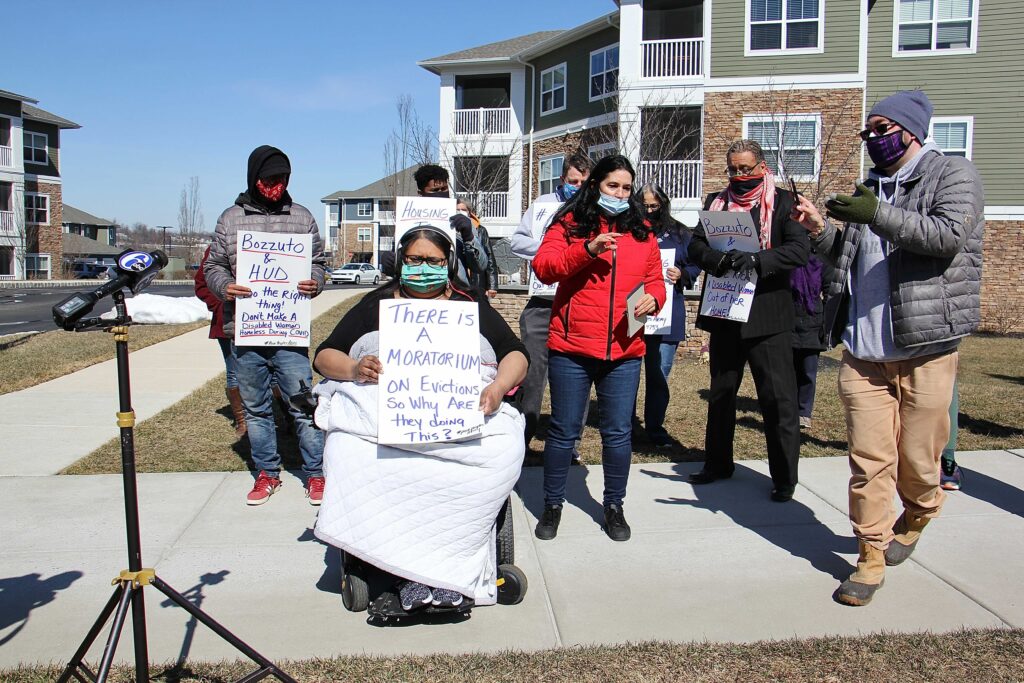 Image from iOS (42) Manisha Divecha, 33, is joined by supporters outside her apartment complex in Malvern