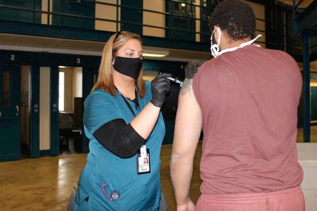PA_DOC_coronavirus_vaccine_prison_031721 A person who is incarcerated receives a COVID-19 vaccine