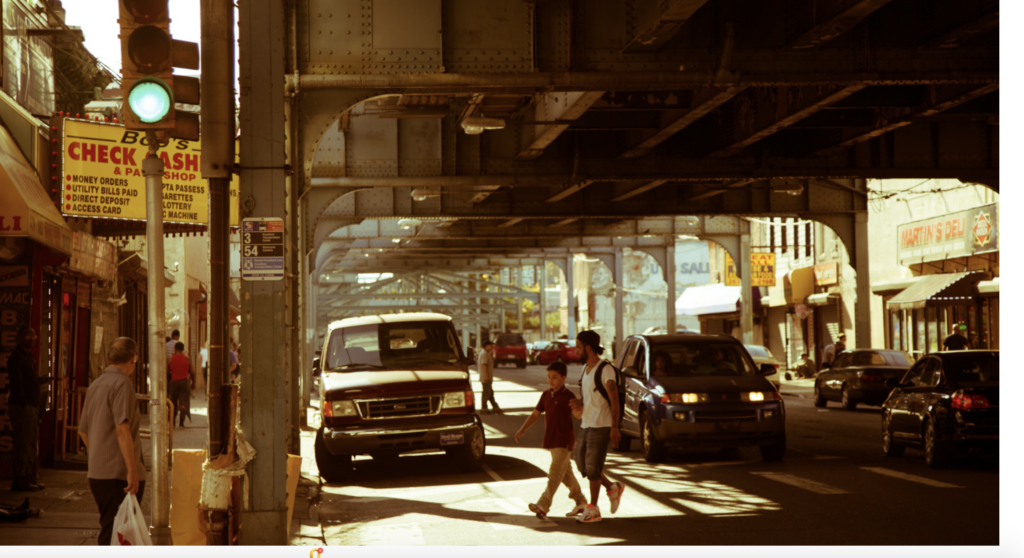 People cross Kensington Avenue to reach the Somerset Station. (NKDC) People crossing the street under the El in Kensington.