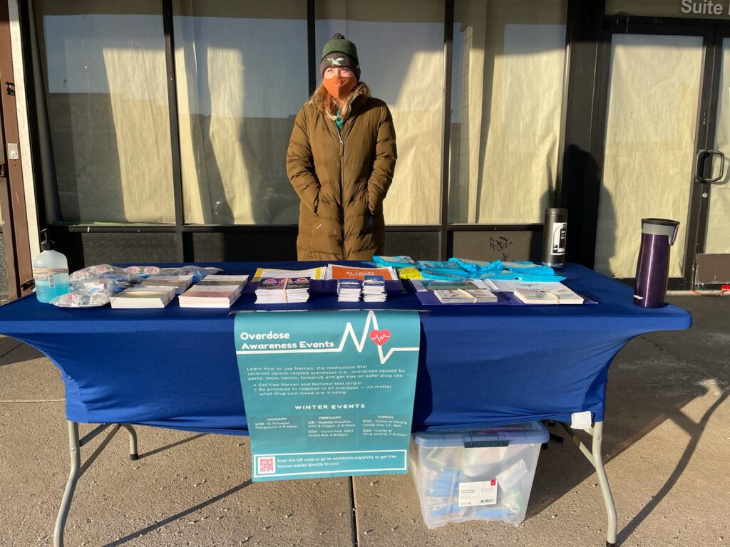 Pop up outreach Jennifer Shinefeld, a field epidemiologist in the Division of Substance Use and Harm Reduction at the Department of Public Health. She is at 24th and Oregon as part of an outdoor ‘pop-up’ to distribute naloxone. (Courtesy of the Philadelphia Department of Public Health)