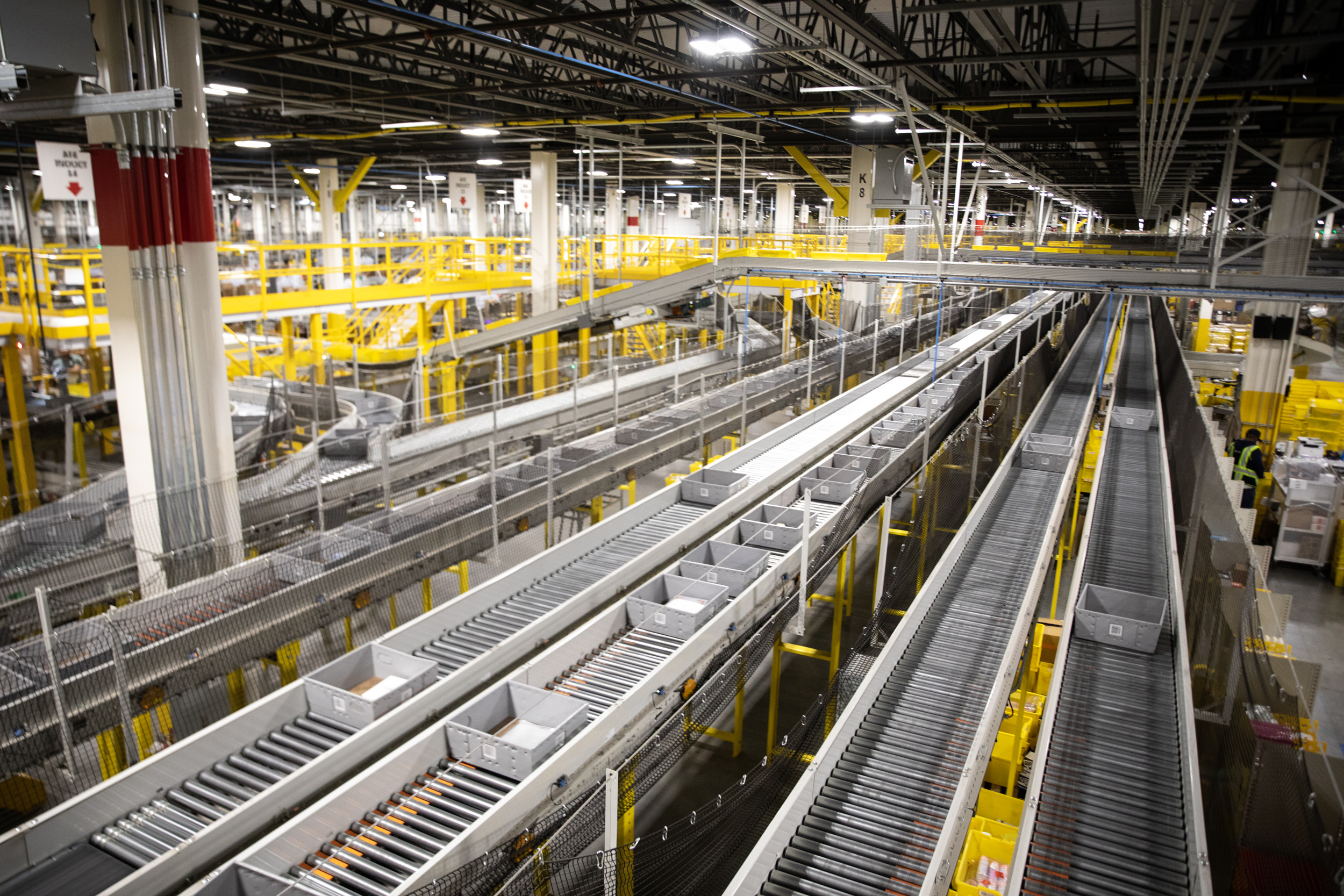 Conveyor belts are pictured an Amazon fulfillment center