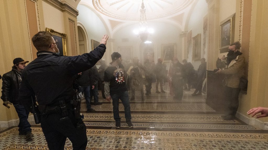Ohio Capitol Breach Glance Smoke fills the walkway outside the Senate Chamber as rioters are confronted by U.S. Capitol Police officers inside the Capitol