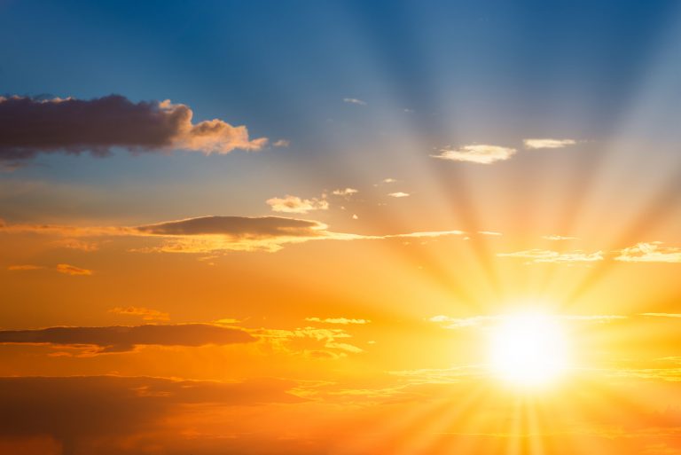 Sun rays on sunset sky