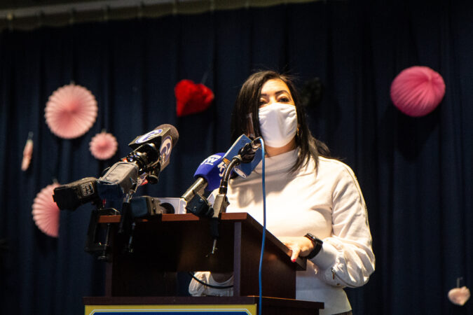 Assistant Superintendent Evelyn Nuñez speaks from a podium