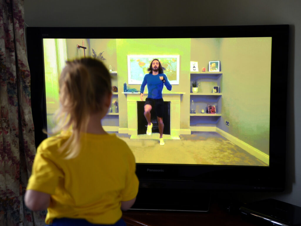 Four-year-old Lois Copley-Jones, the photographer’s daughter, takes part in a livestreamed broadcast of “PE With Joe” on March 23, 2020, in Newcastle-under-Lyme, England. The popular fitness series ended Friday. Four-year-old Lois Copley-Jones, the photographer's daughter, takes part in a livestreamed broadcast of