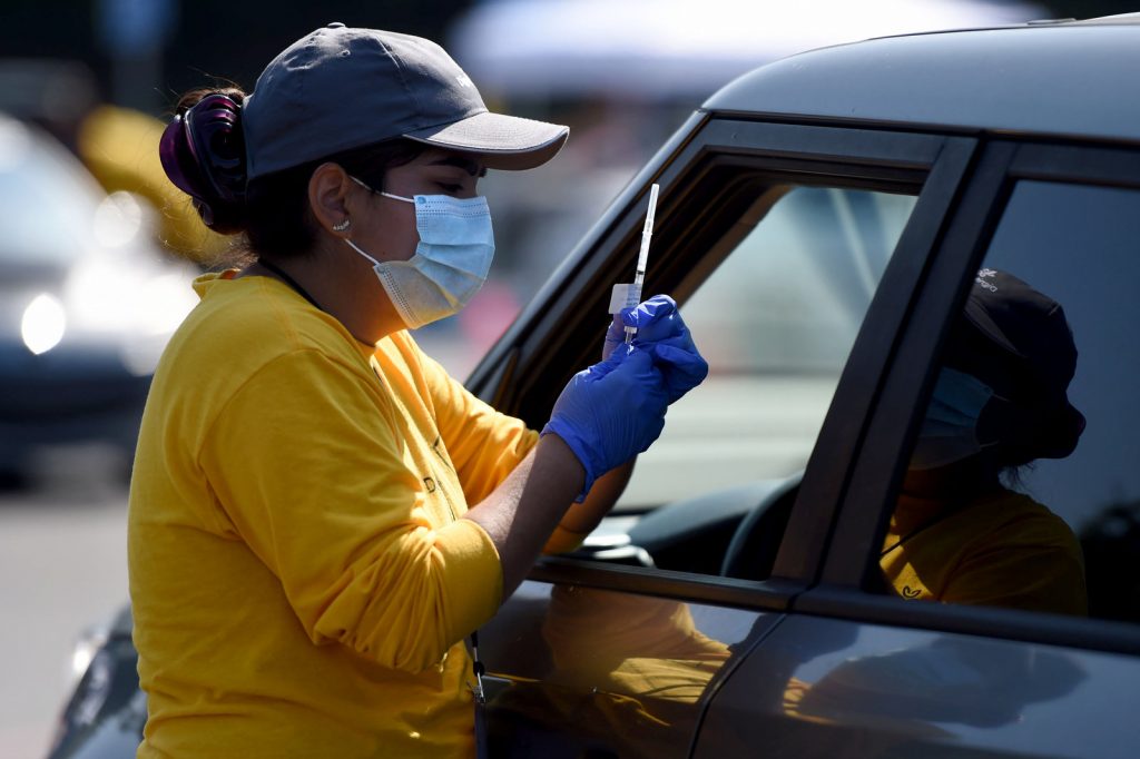 People get their second dose of the COVID-19 vaccine at Dignity Health Sports Park A worker prepares to give a COVID-19 vaccine at the Dignity Health Sports Park