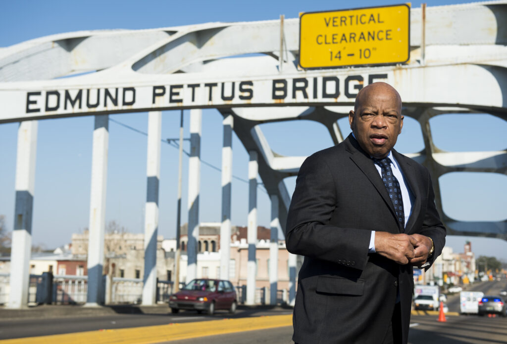 The late Rep. John Lewis stands on the Edmund Pettus Bridge in Selma, Ala., in 2015, where he was beaten by police on “Bloody Sunday.” John Lewis stands on the Edmund Pettus Bridge