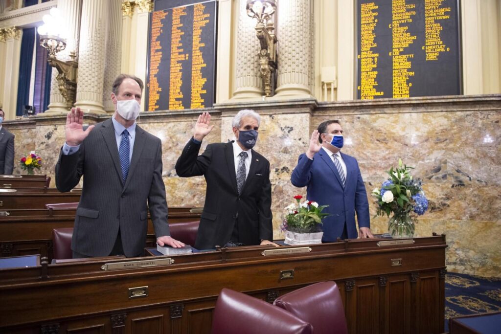 Democrats Rep. Mark Longietti (left) and Chris Sainato (center) raise their right hands
