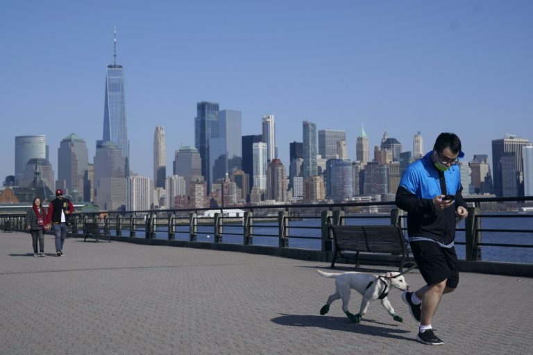A man jogs with his dog at Liberty State Park in Jersey City