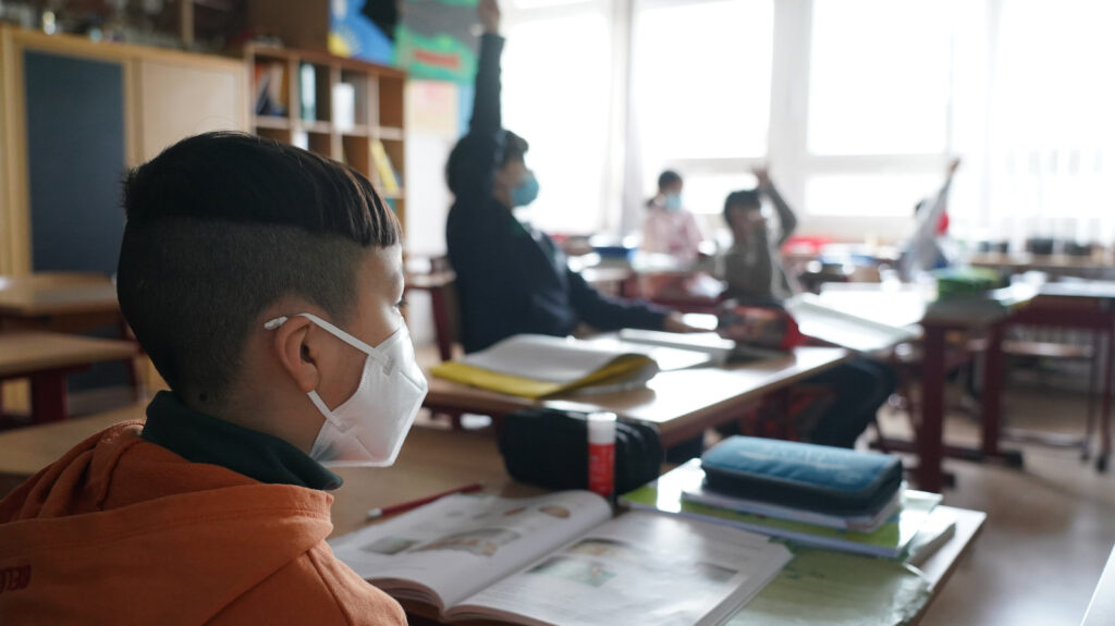 More Students Return To School During Pandemic Third grade children attend school while wearing face masks