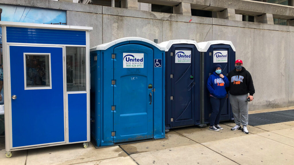 portapotties-msb-centercitytoilets-crop One Day At A Time's Terry Wagner and John Smutnik staff the trio of porta-potties at their new 15th and Arch location. (Michaela Winberg/Billy Penn)