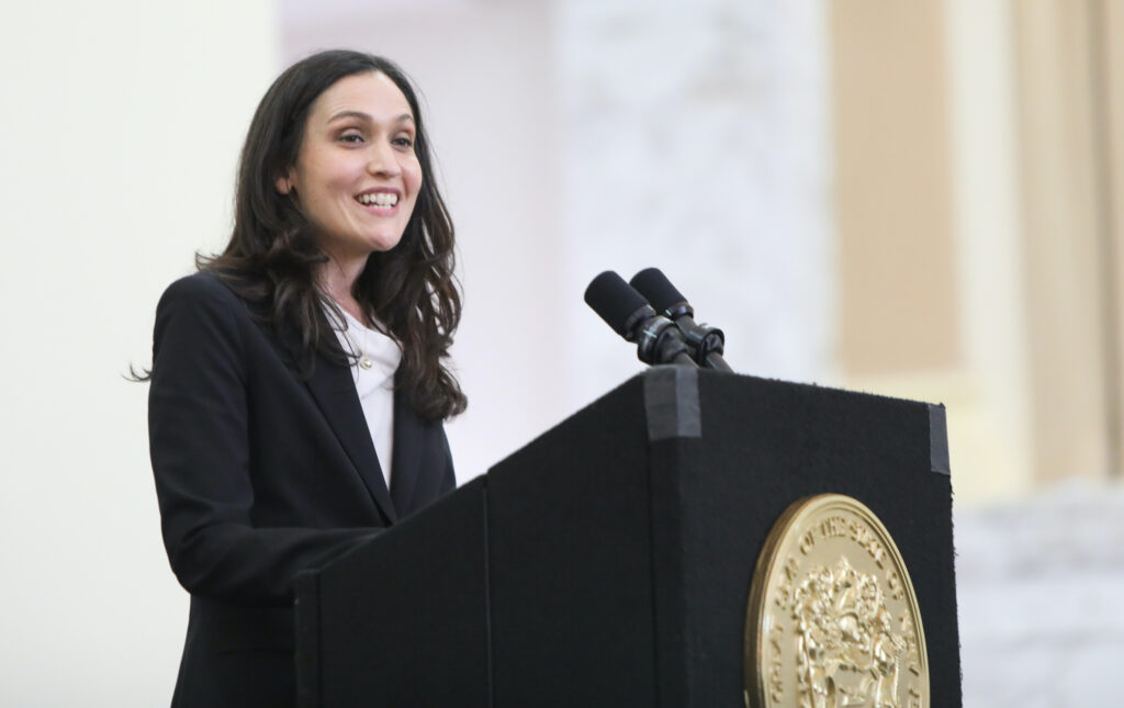 rachel_wainer_apter Rachel Wainer Apter speaks from a podium at Ruth Bader Ginsburg Hall
