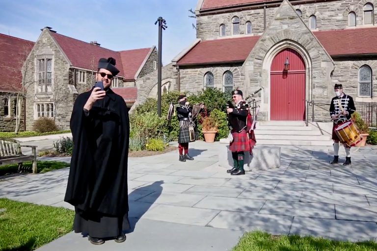 Rev. Jarrett Kerbel (left) leads a three-person band as they bring Easter hymns to Chestnut Hill on April 12, 2020. (Emily Cohen for WHYY)