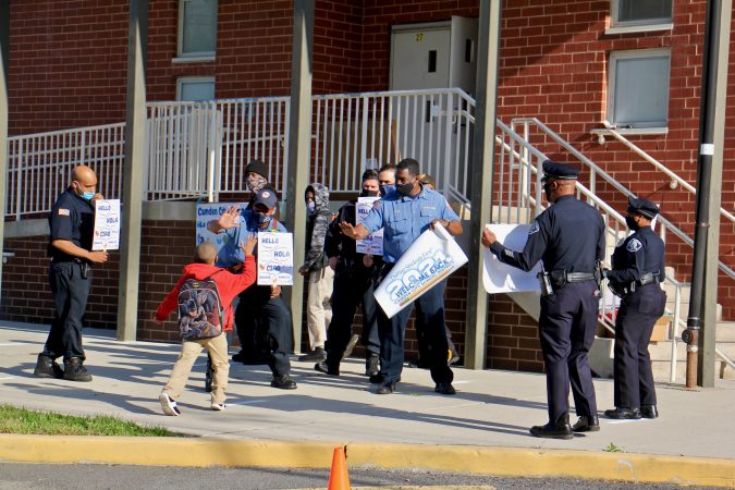 Devine Burton, 7, is greeted with enthusiasm as he arrives for his first in-person first grade class
