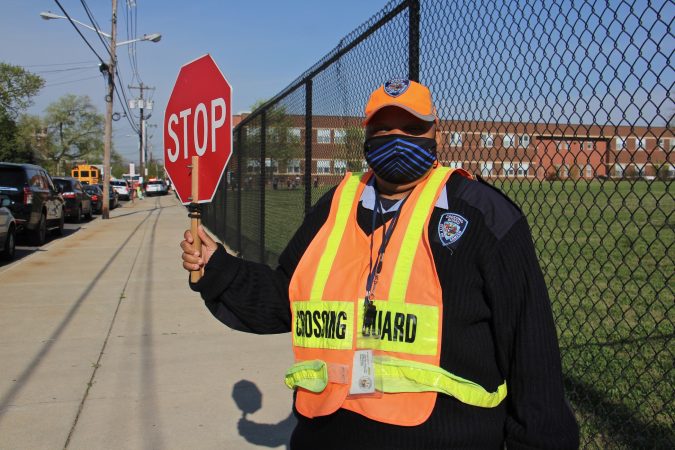 Marcella Vincent holds up a crossing guard sign
