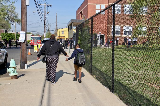 Ni G Kinard escorts her son, Keith Kinard III, 8, to opening day